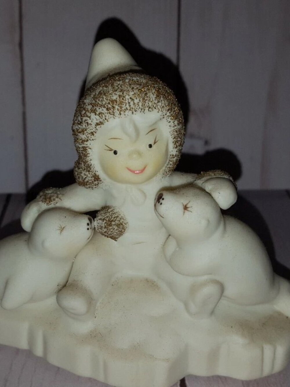 4" tall by 5" wide Wellington collection figurine child with seals in snow